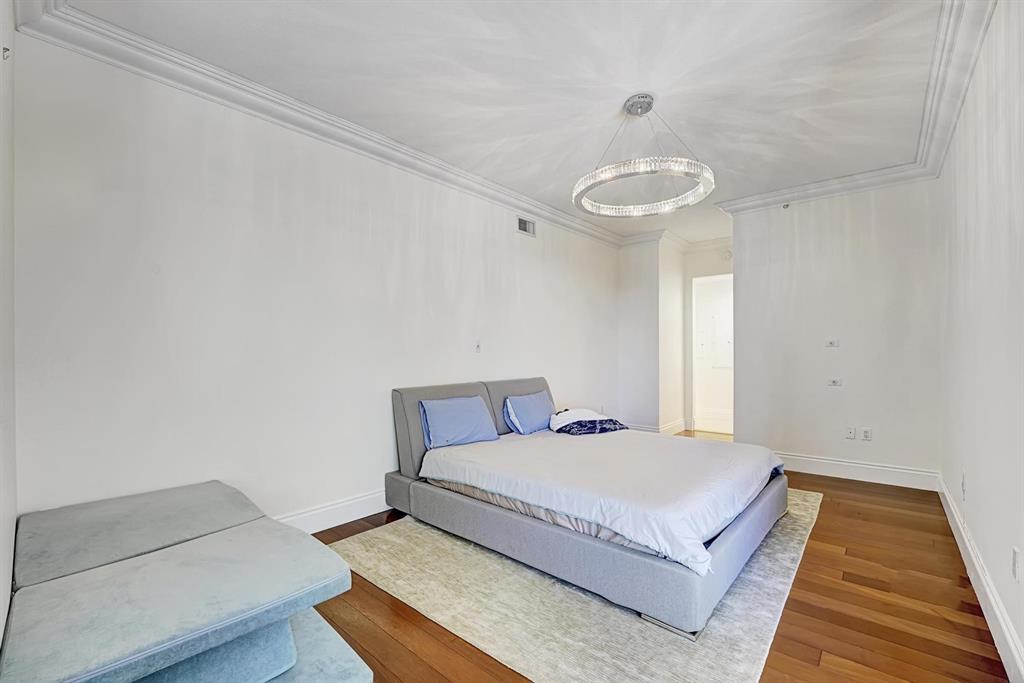 1 North Ocean Boulevard, Unit 403 Boca Raton, FL 33432 - Photo 19 of 46 a bedroom with a bed and a night stand