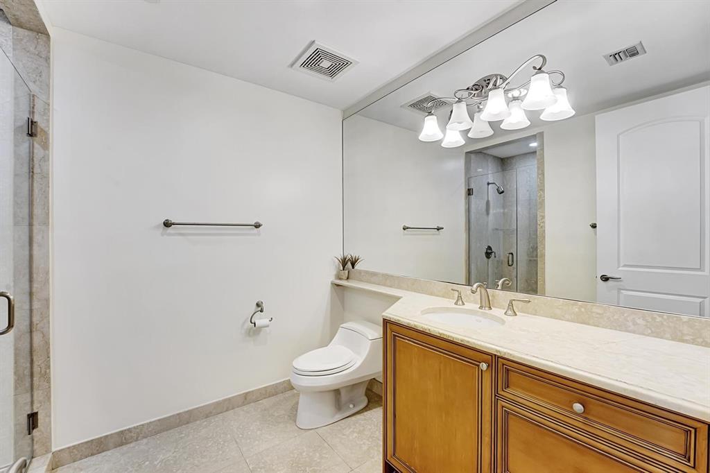 1 North Ocean Boulevard, Unit 403 Boca Raton, FL 33432 - Photo 20 of 46 a bathroom with a sink a toilet and a mirror