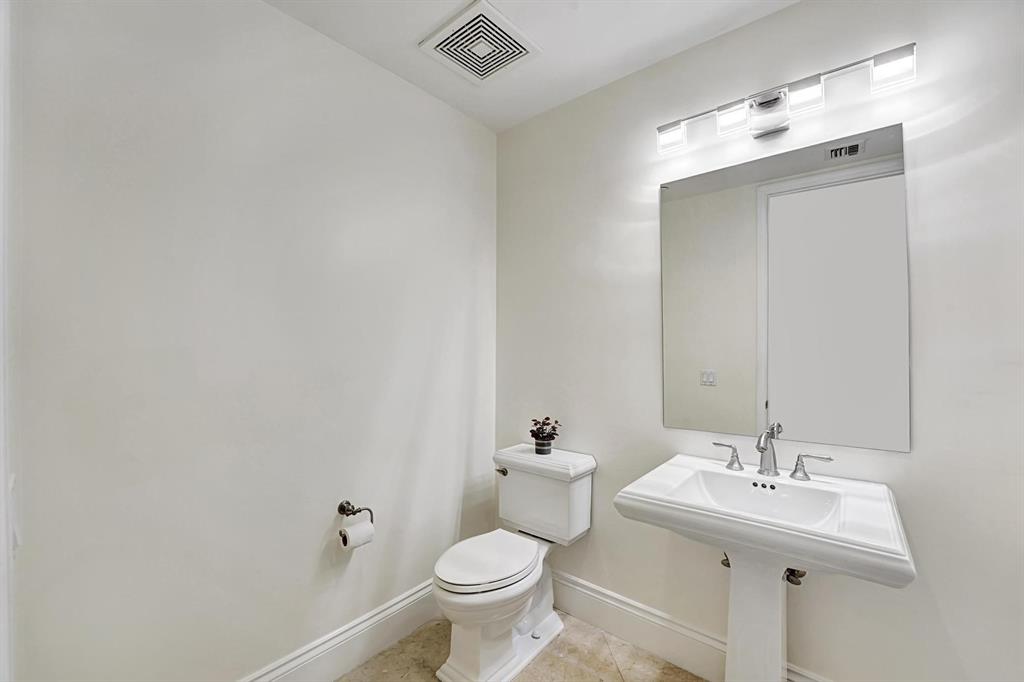 1 North Ocean Boulevard, Unit 403 Boca Raton, FL 33432 - Photo 22 of 46 a bathroom with a sink toilet and a mirror