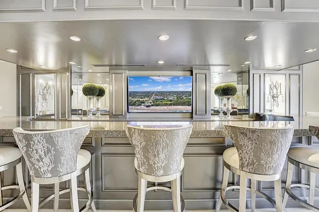 a dining table with chairs and window