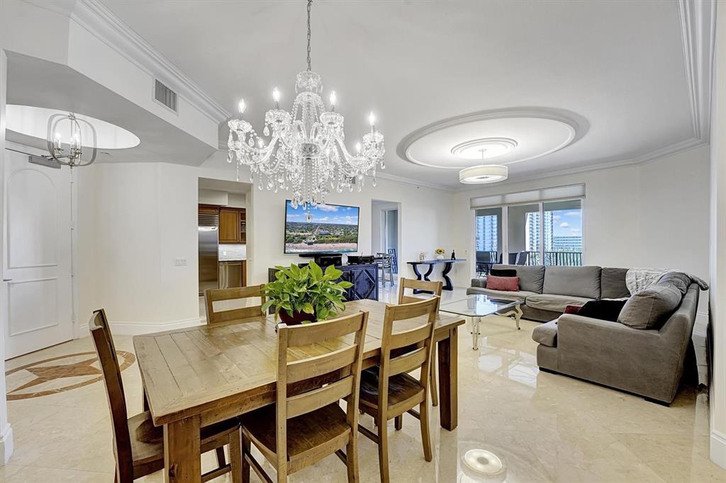 1 North Ocean Boulevard, Unit 403 Boca Raton, FL 33432 - Photo 3 of 46 a living room with furniture and a chandelier