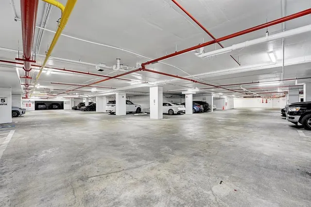 a view of parking garage with cars