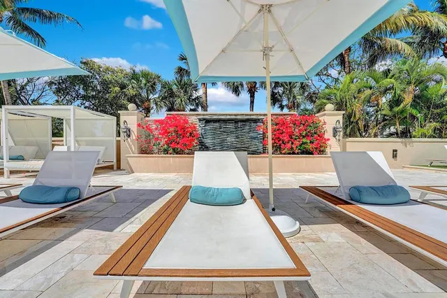a view of a building with couches table and chairs