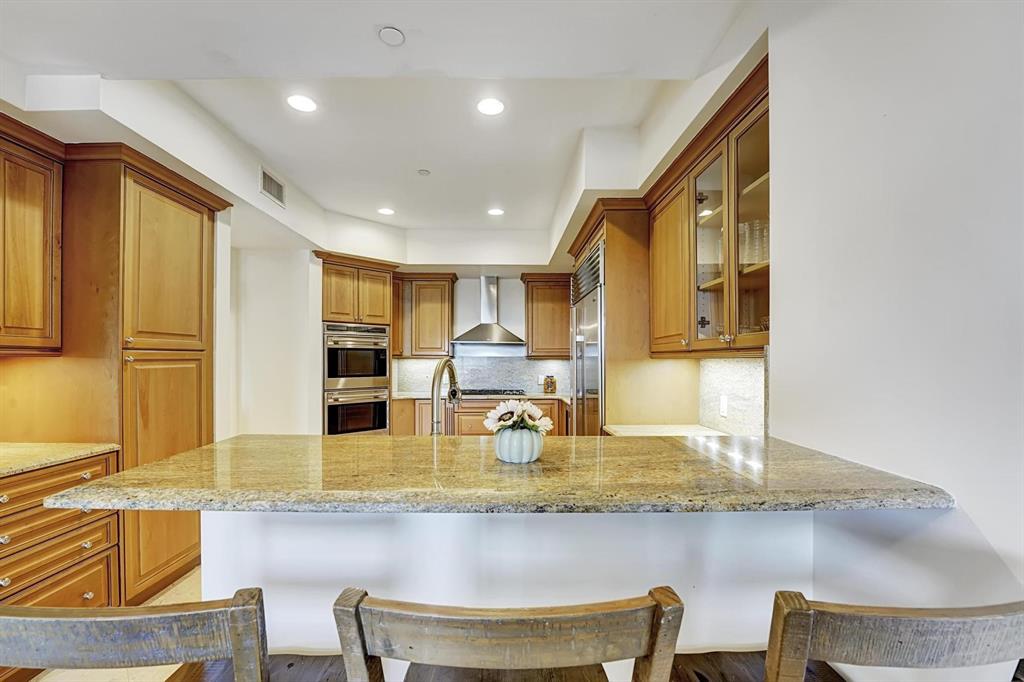 1 North Ocean Boulevard, Unit 403 Boca Raton, FL 33432 - Photo 8 of 46 a kitchen with dining table and chairs