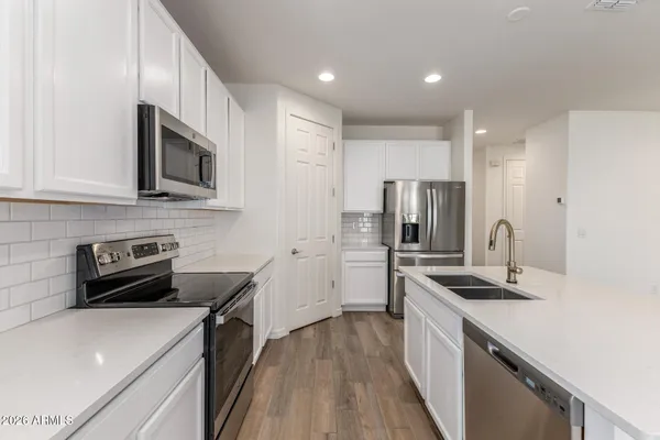 a kitchen with kitchen island granite countertop a stove and a sink