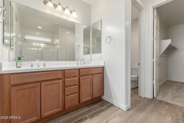 a bathroom with a double vanity sink and a mirror