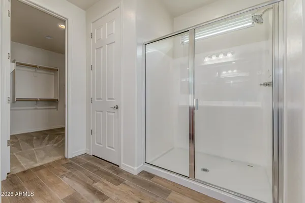 a bathroom with a glass shower door