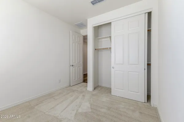 an empty room with closet area