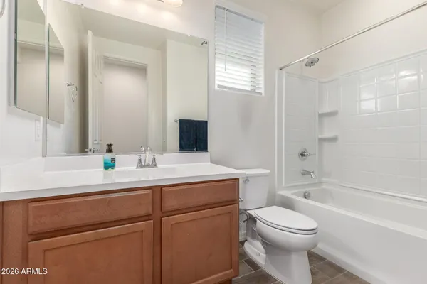 a bathroom with a sink toilet vanity and shower