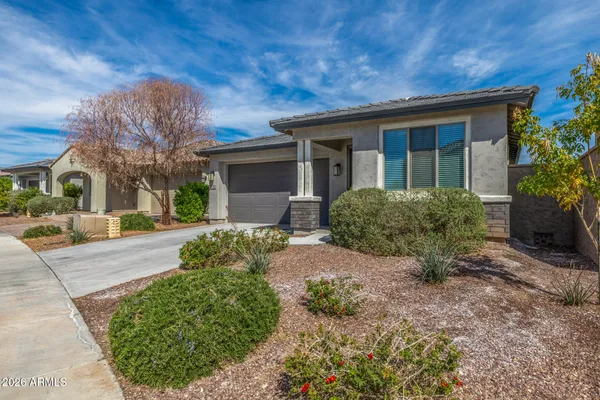 a view of a house with a yard and pathway