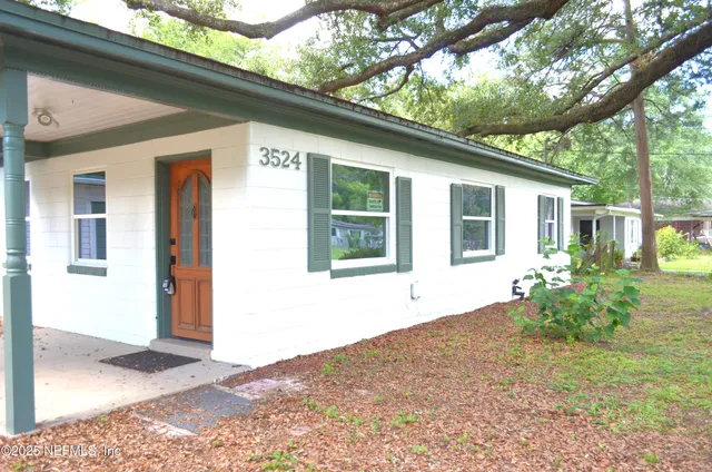 a front view of a house with garden