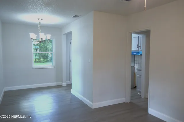 an empty room that has a window in it