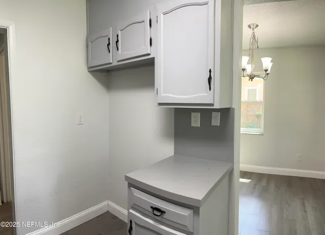 a room with cabinets and wooden floor