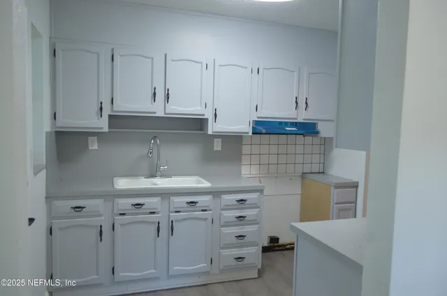 a kitchen with cabinets appliances and a counter top