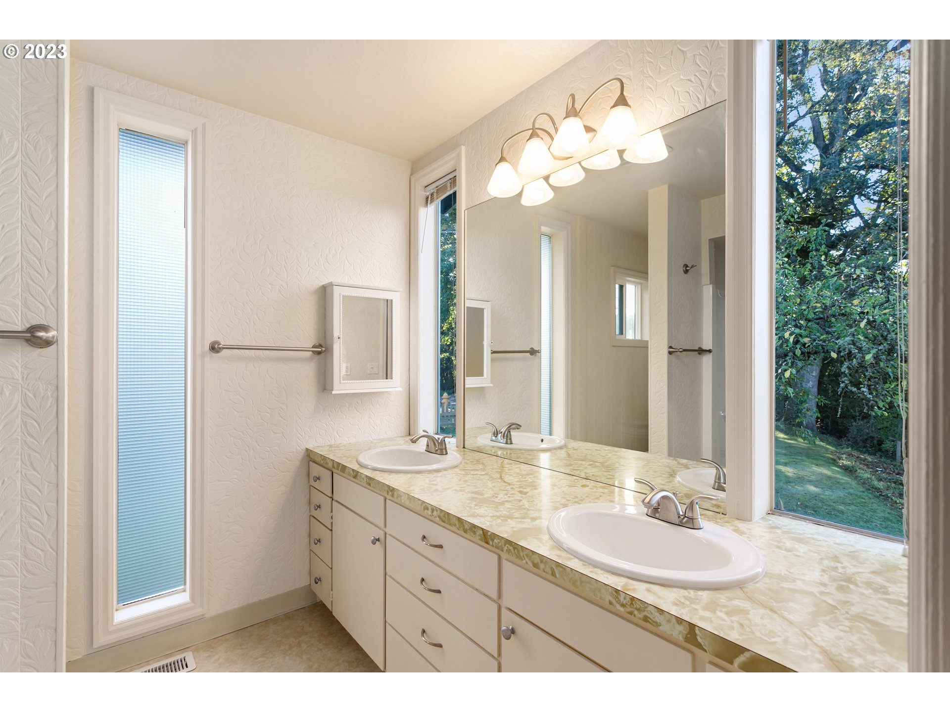 125 South Main Avenue Ridgefield, WA 98642 - Photo 23 of 35 a bathroom with a double vanity sink and a mirror