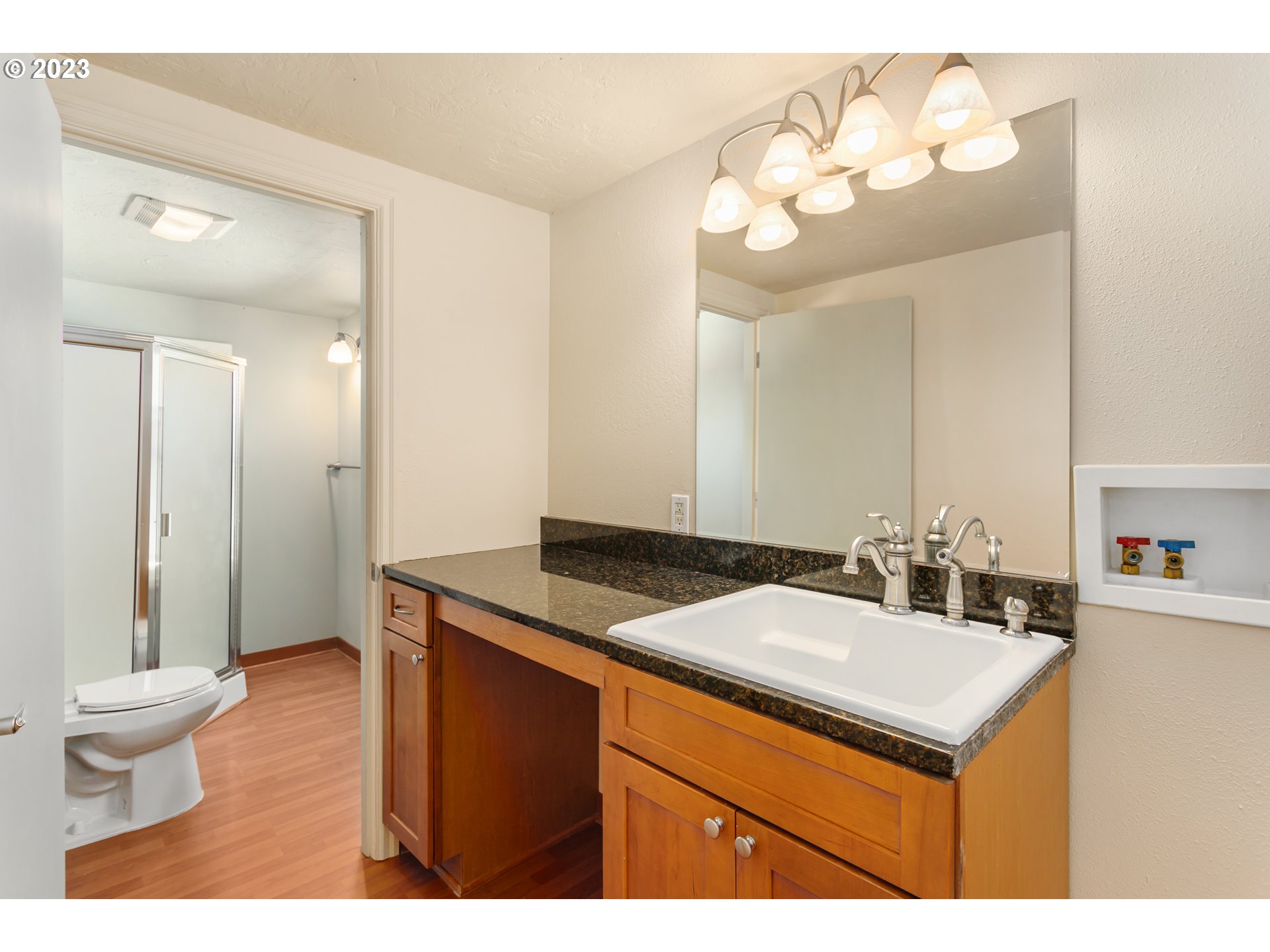 125 South Main Avenue Ridgefield, WA 98642 - Photo 27 of 35 a bathroom with a sink a toilet and a mirror