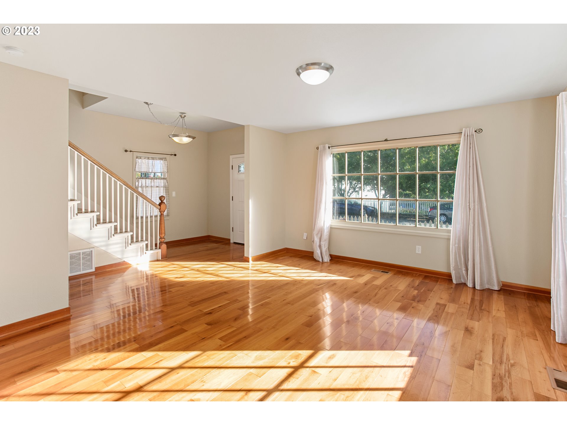 125 South Main Avenue Ridgefield, WA 98642 - Photo 6 of 35 a view of an empty room with wooden floor and a window