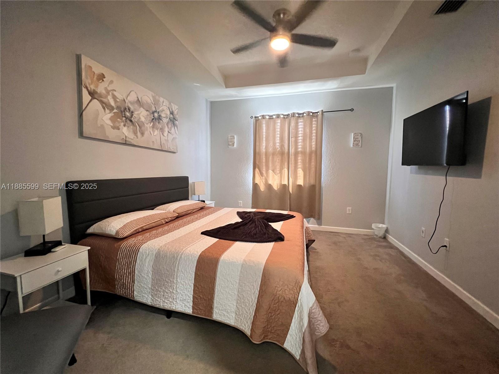 159 Southeast 34th Avenue Homestead, FL 33033 - Photo 11 of 27 a bedroom with a bed and a flat screen tv
