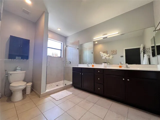 a bathroom with a sink vanity mirror and toilet