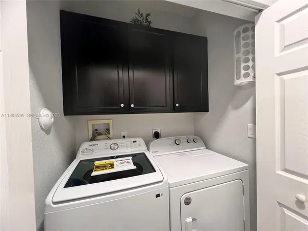 a utility room with dryer and washer