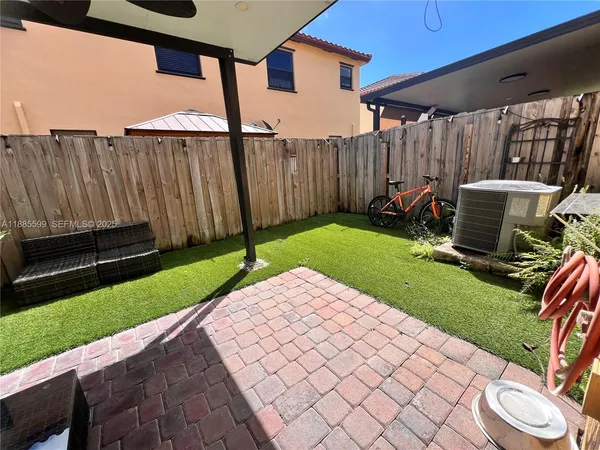a view of a backyard with sitting area