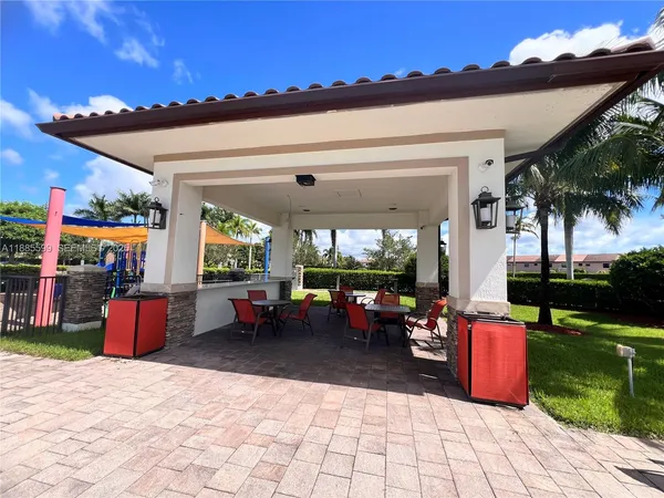 a building outdoor space with patio furniture and garden