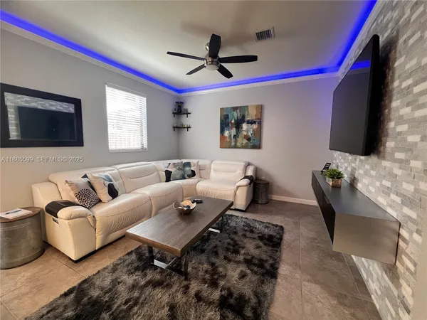a living room with furniture and a flat screen tv
