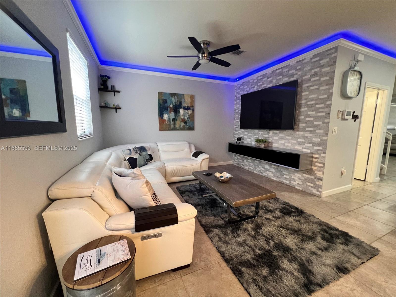 159 Southeast 34th Avenue Homestead, FL 33033 - Photo 9 of 27 a living room with furniture and a flat screen tv