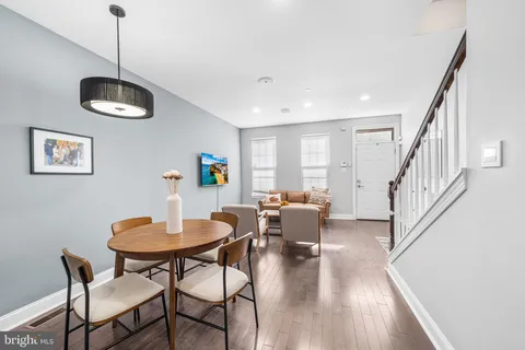 a dining room with furniture and wooden floor