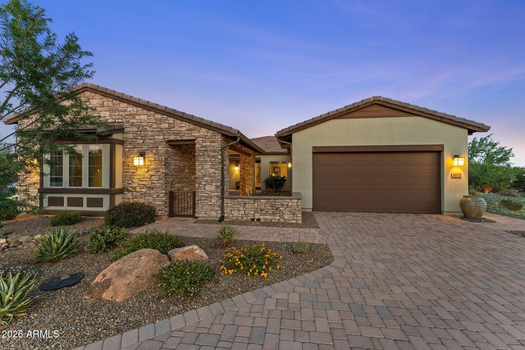 3675 Gold Ridge Road Wickenburg, AZ 85390 - Photo 55 of 58 a front view of a house with a yard and garage