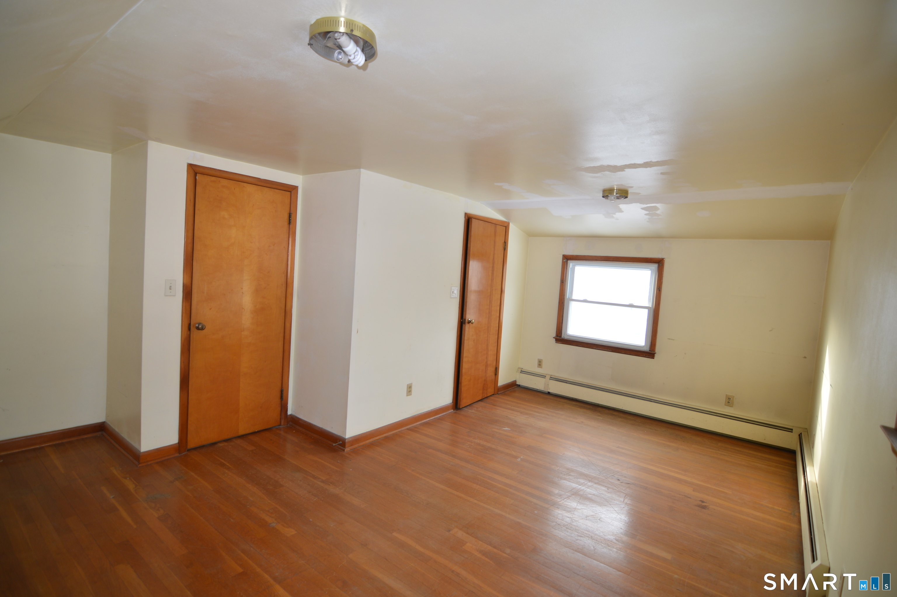 120 Chelsea Street Stratford, CT 06615 - Photo 15 of 17 an empty room with wooden floor and windows