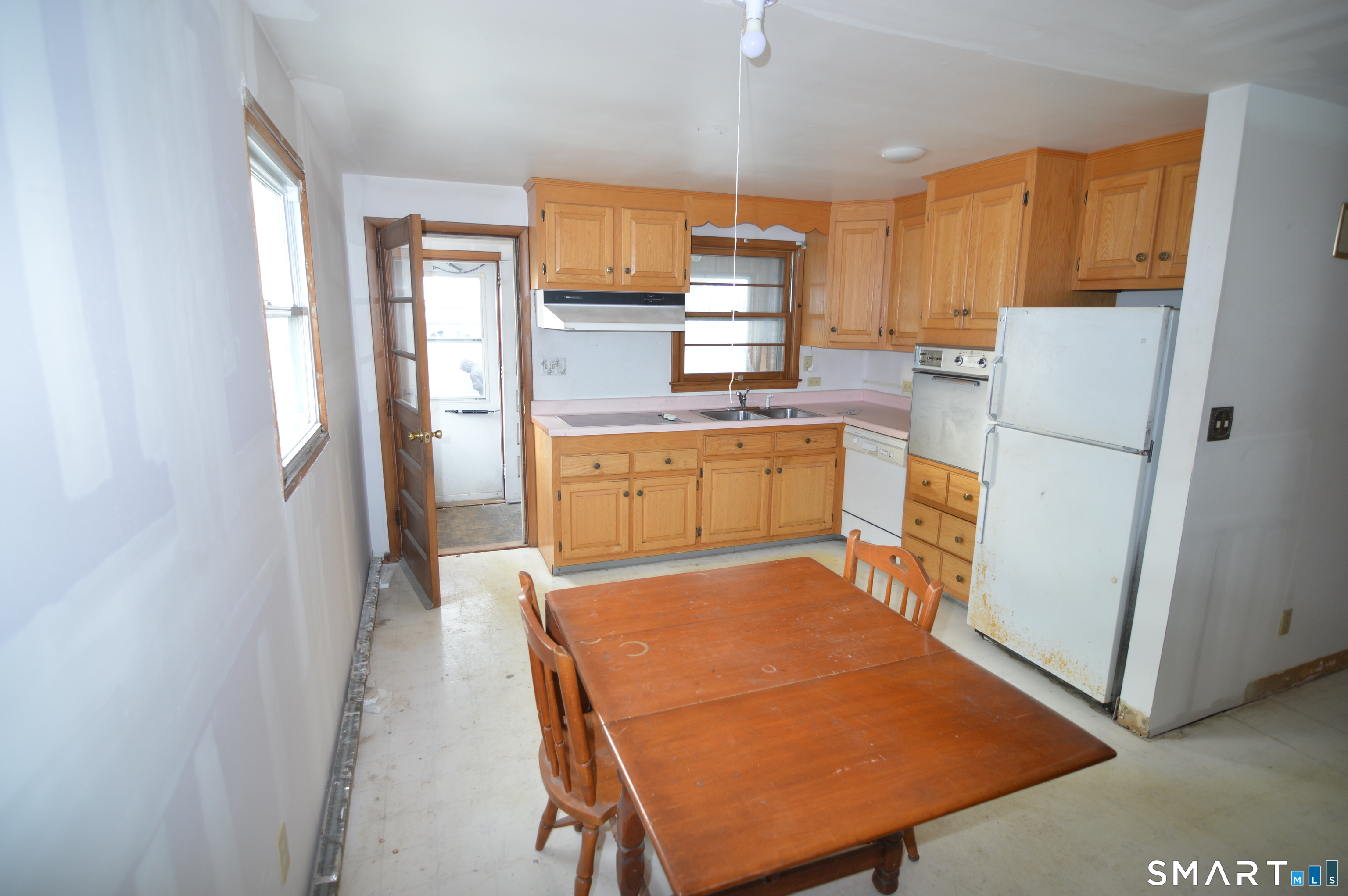 120 Chelsea Street Stratford, CT 06615 - Photo 8 of 17 a kitchen with stainless steel appliances granite countertop a refrigerator a stove a sink dishwasher and white cabinets with wooden floor