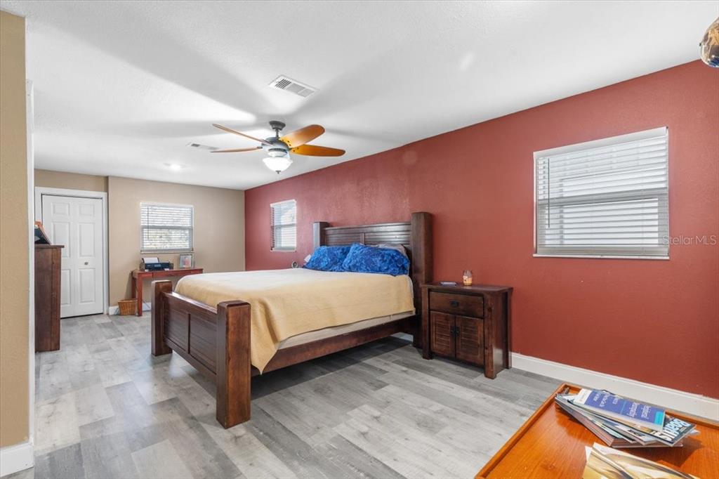 7226 Alafia Ridge Loop Riverview, FL 33569 - Photo 19 of 51 a bedroom with a bed and a chandelier