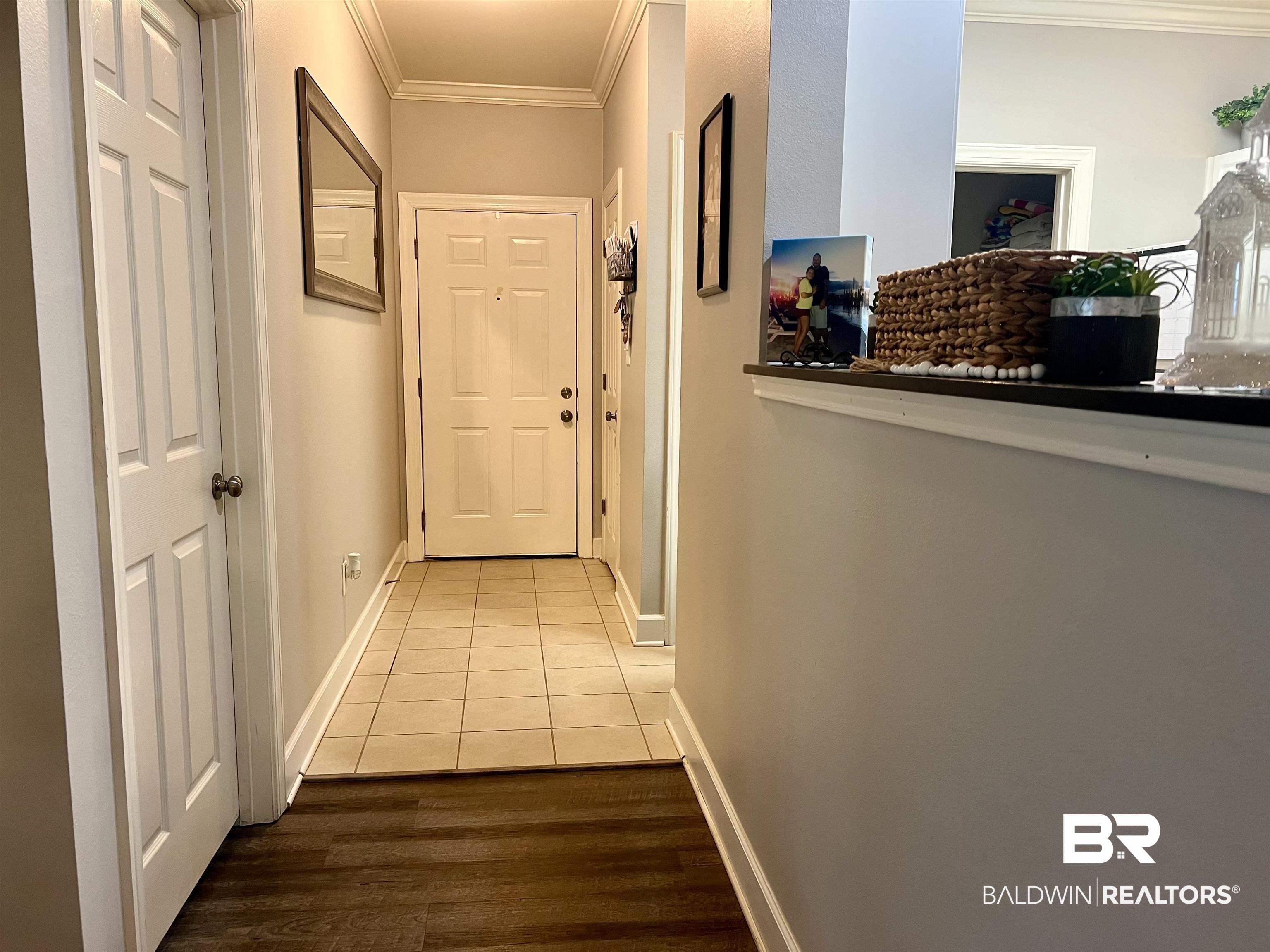 450 Park Avenue, Unit 808 Foley, AL 36535 - Photo 12 of 38 Hallway featuring tile patterned floors and ornamental molding