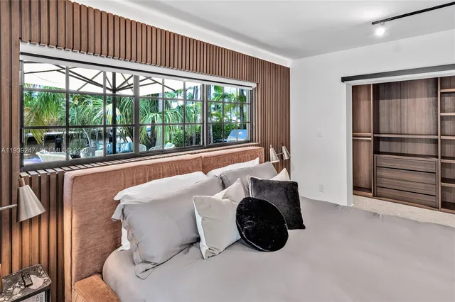 a bedroom with bed and a window