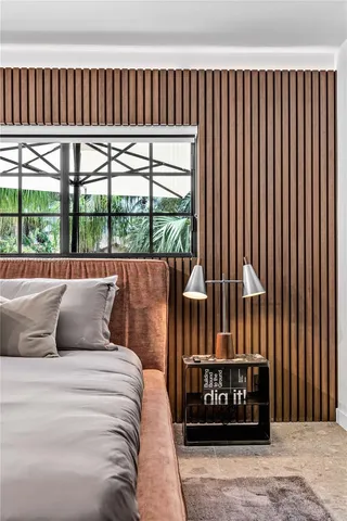 a bedroom with a large bed and a large window