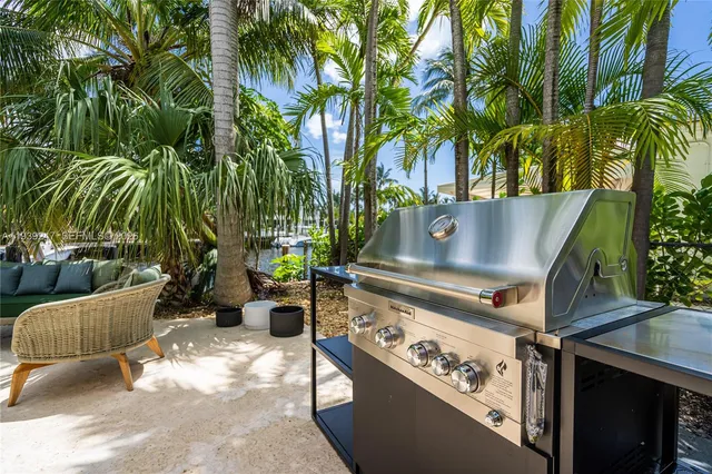 an aerial view of a city with lots of residential buildings ocean and mountain view in back