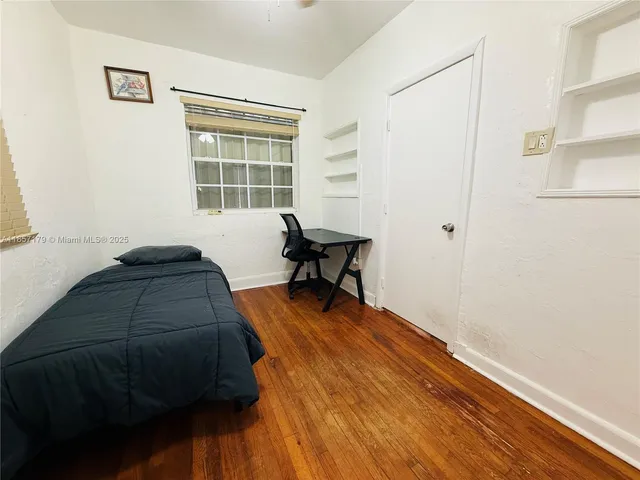 a living room with a bed furniture and a window