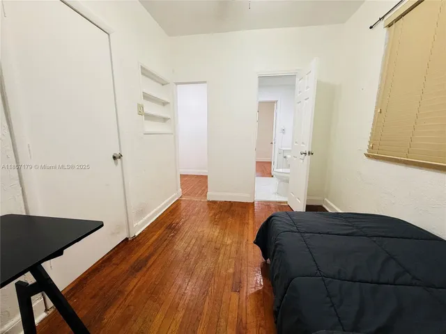 a view of bedroom and bedroom with wooden floor