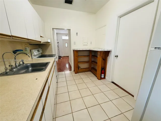 a kitchen with a sink and cabinets
