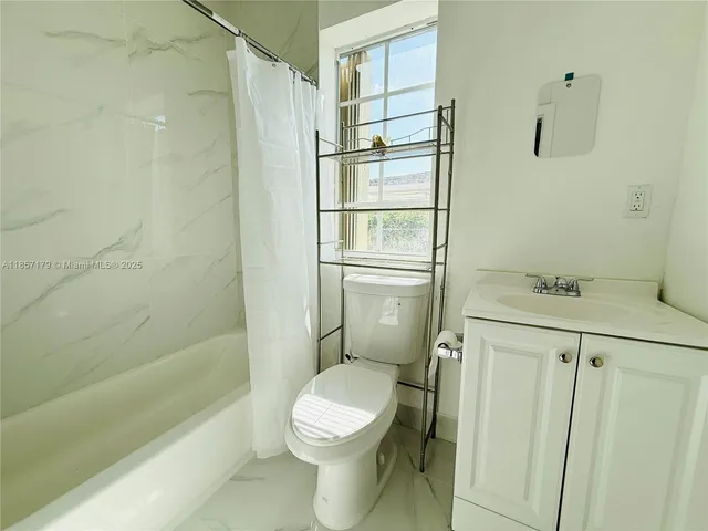 a bathroom with a toilet a sink and shower