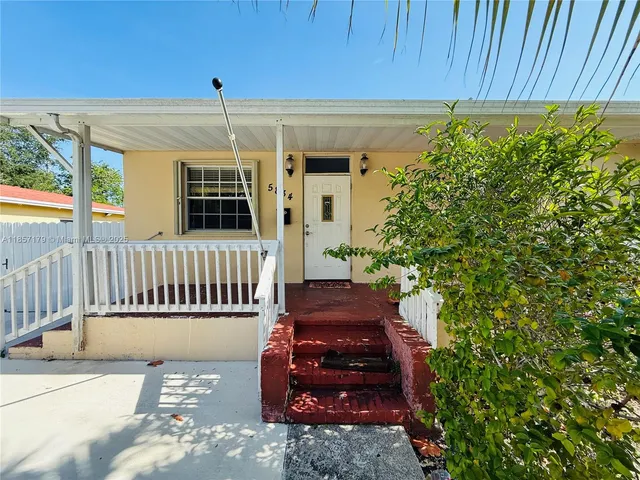 a view of a house with a small yard