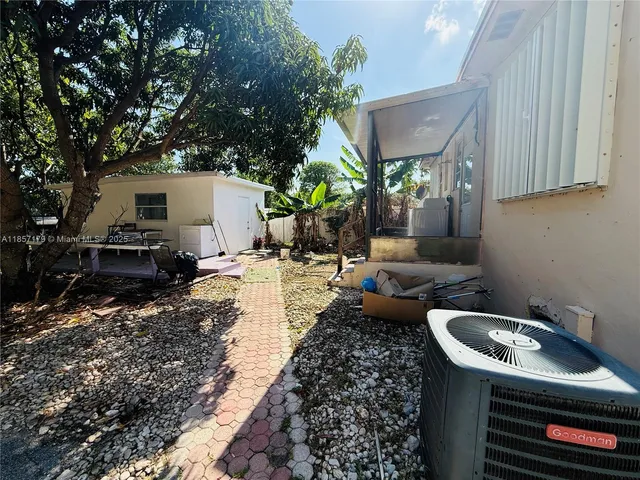 a view of a backyard with white house