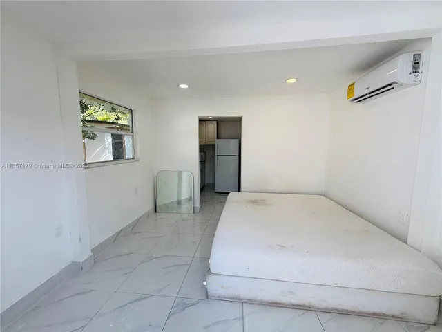 a kitchen with cabinets and a refrigerator