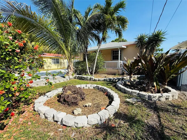 a view of a house with swimming pool and sitting area