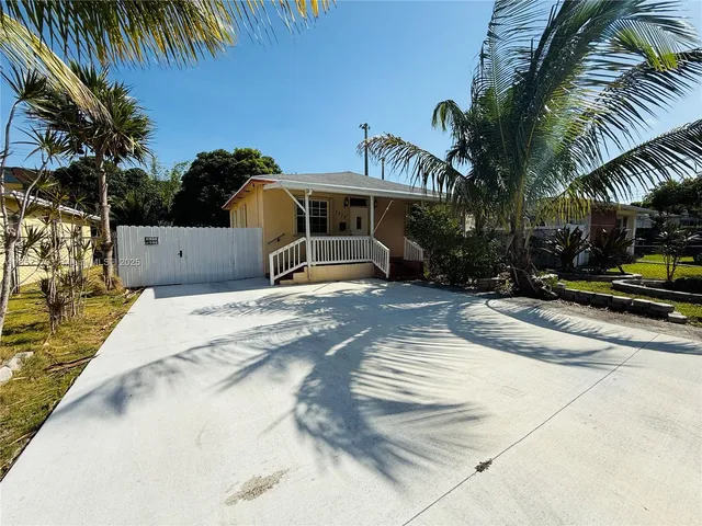 a view of a white house with a swimming pool