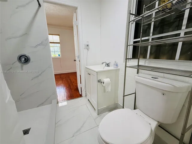 a white toilet sitting next to a bathroom sink