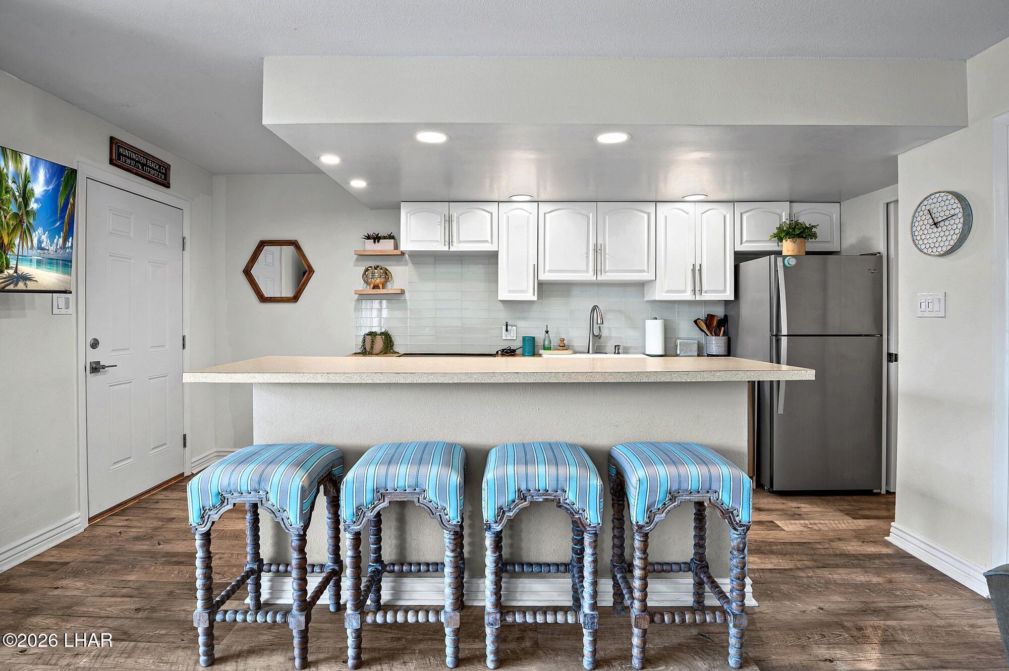 9170 Riverside Drive, Unit 13 Parker, AZ 85344 - Photo 11 of 51 a kitchen with stainless steel appliances granite countertop a table chairs refrigerator and sink