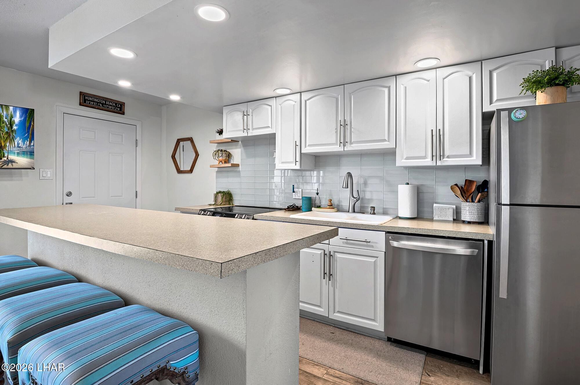 9170 Riverside Drive, Unit 13 Parker, AZ 85344 - Photo 14 of 51 a kitchen with cabinets and stainless steel appliances