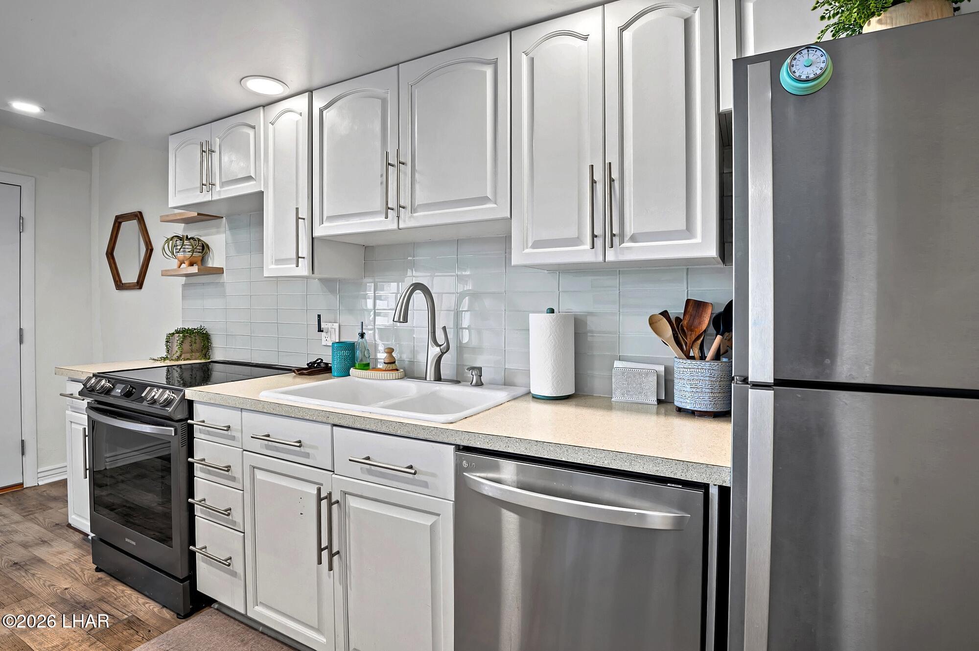 9170 Riverside Drive, Unit 13 Parker, AZ 85344 - Photo 15 of 51 a kitchen with appliances cabinets and a sink